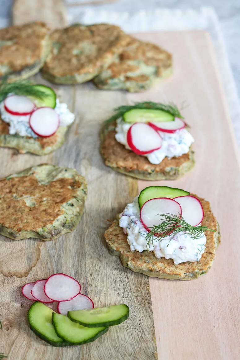 Potato and cottage cheese pancakes with dill, radish, and cucumber on top